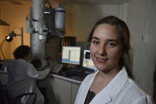 Portrait of Maria TorresArango in the lab with Marcela in the background
